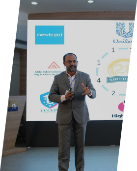 A group of students smiling during a language training session.